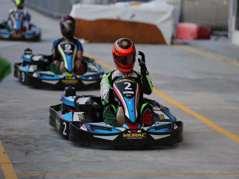 Tourists adjusting helmet while go-karting at Morac Adventure Park Langkawi