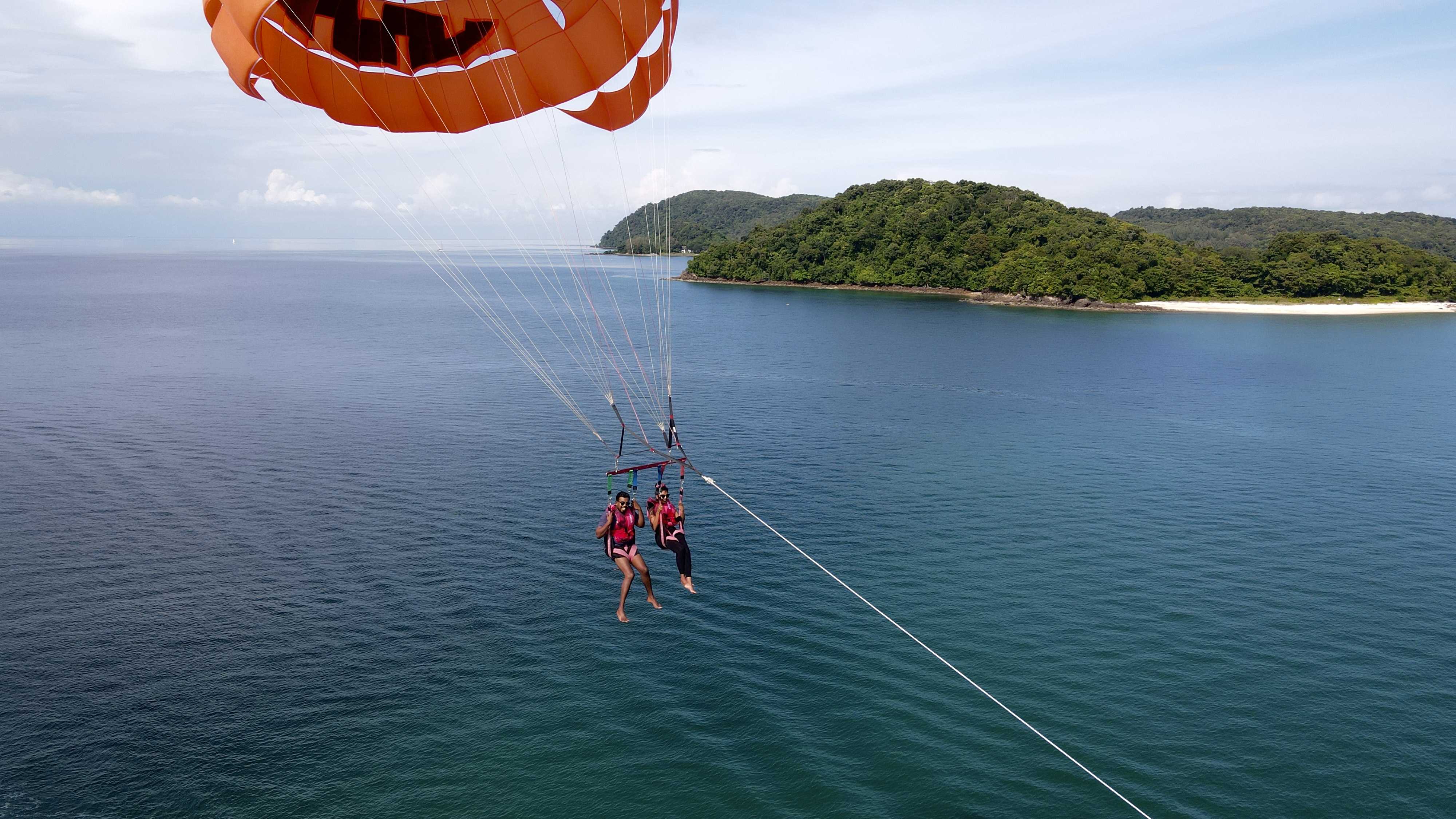 Tourists parasailing on a boat at Langkawi Jetski and Watersports Tour